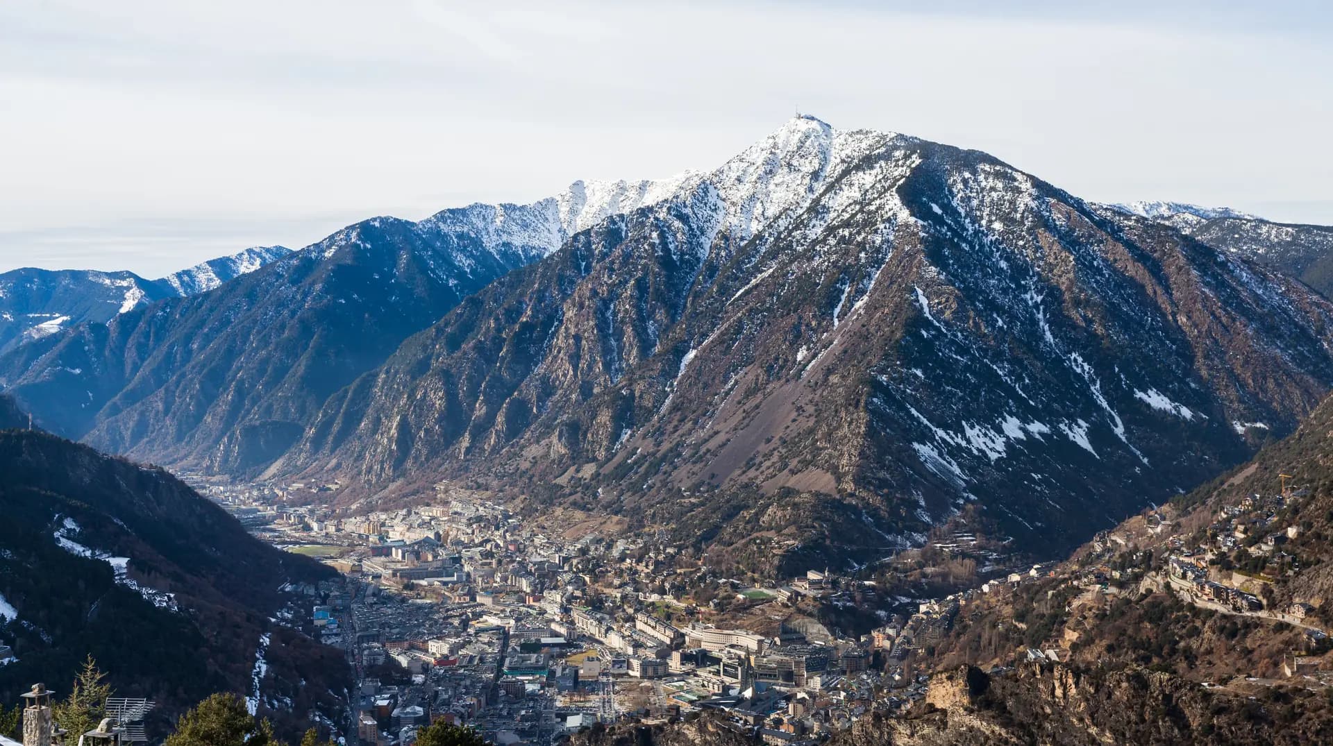 Andorra la Vella in the valley floor beneath snow-dusted mountains