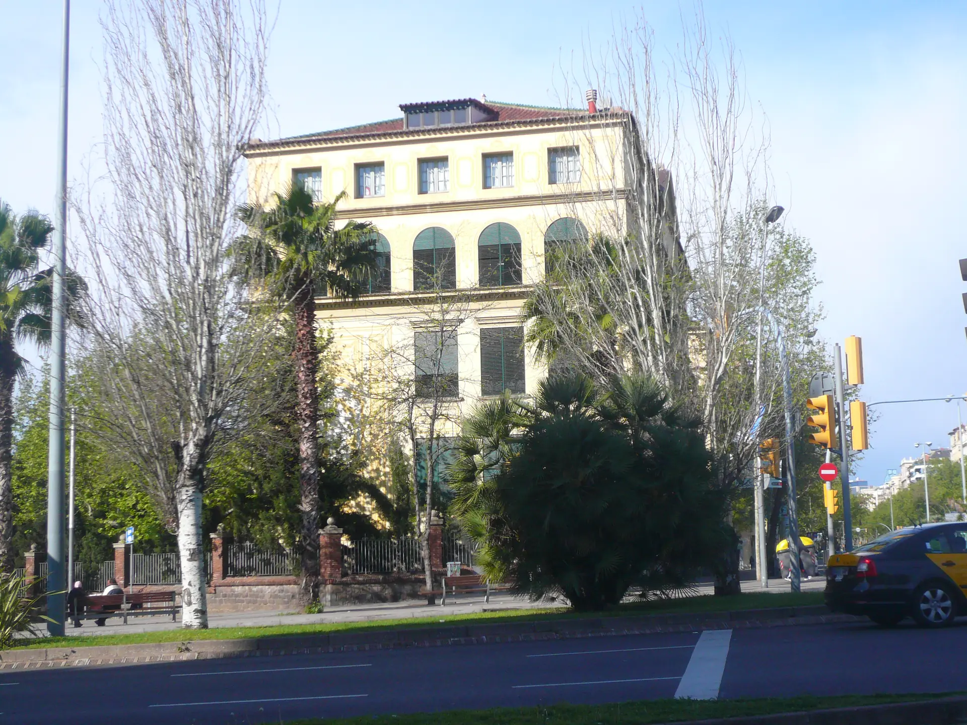 The Ramon Llull school building in Barcelona among palm trees
