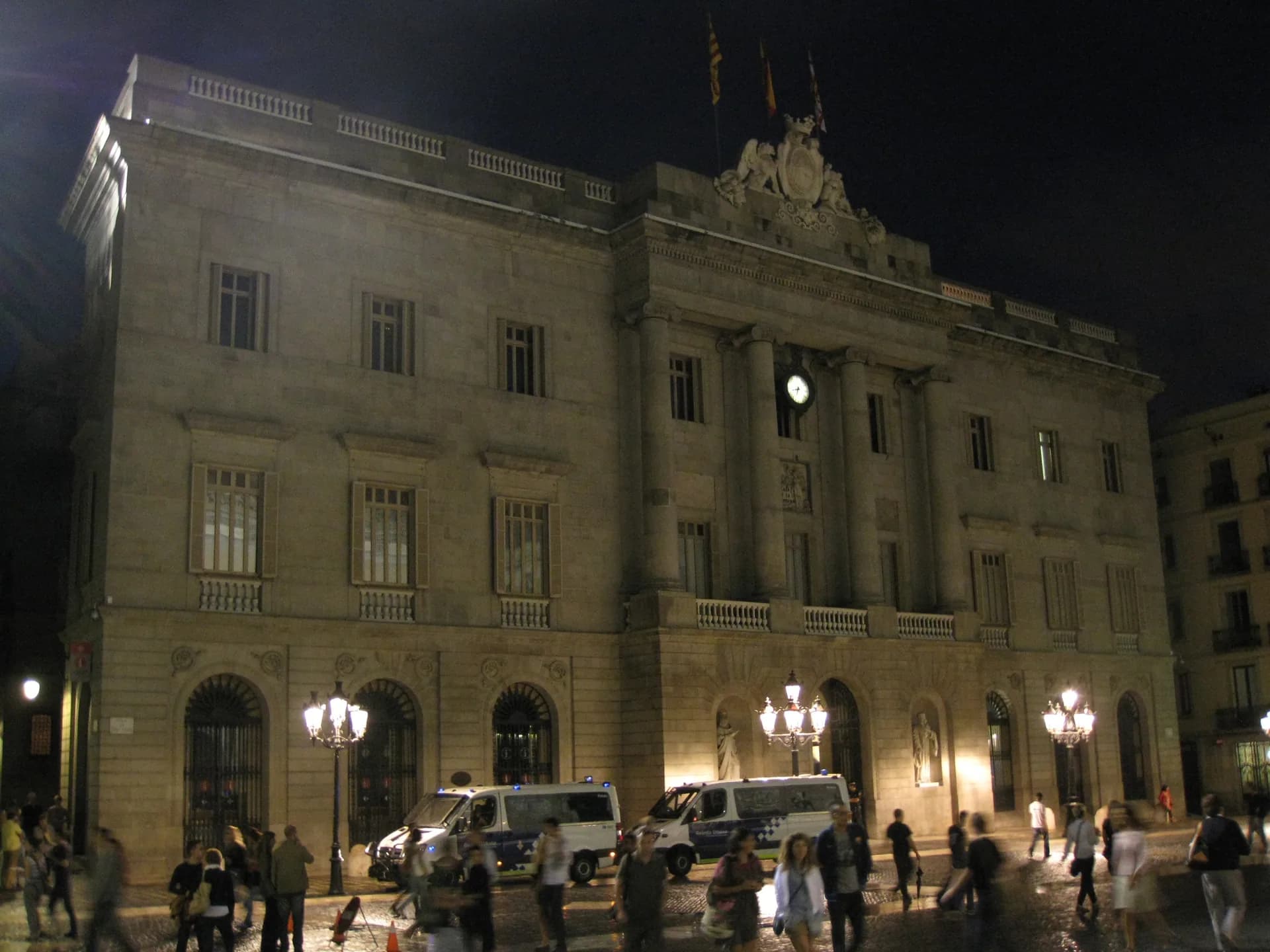 The façade of Barcelona City Hall lit up at night in Plaça de Sant Jaume