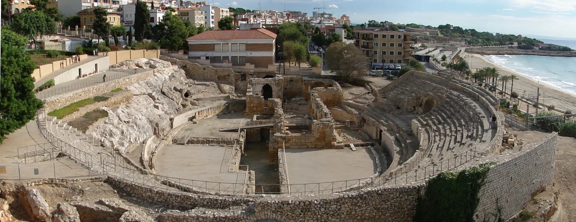 Tarragona's Roman amphitheatre with the sea and beach on the right