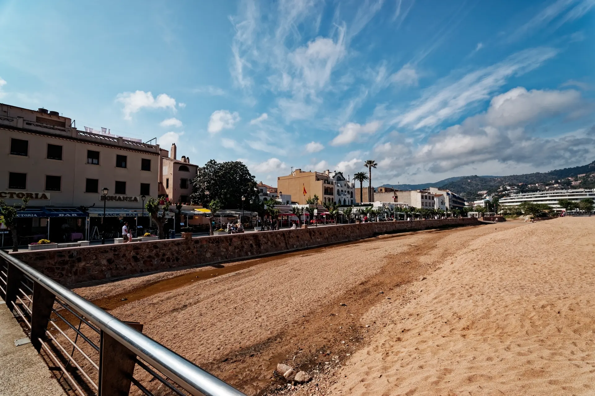 The seafront promenade and main beach at Tossa de Mar, lined with hotels and restaurants